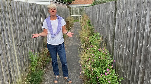 Councillor Paula Widdowson standing in the overgrown Carrfield snicket