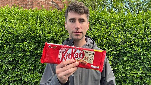 Cllr Smalley holding a packet of KitKats