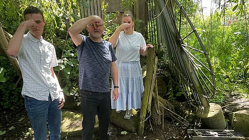 Hull Road campaigners standing in front of the Hull Rd sewage outflow, holding their noses